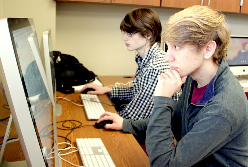 LYNN KUTTER ENTERPRISE-LEADER Lincoln High students Jeremy Miller, right, and Tony Ellis work on their project to produce a video for the University of Arkansas about its Adopt-a-Classroom program. Rebecca Martindale, with UA, has adopted the EAST Lab Initiative at Lincoln High School.