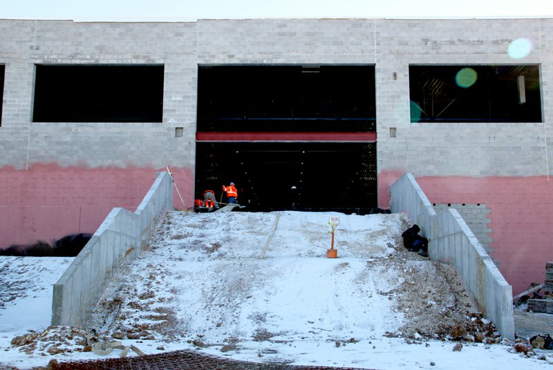 LYNN KUTTER ENTERPRISE-LEADER Snow covers the entrance area to Prairie Grove High School&#8217;s new basketball gym. School Board members voted to use bricks along the sides of the entrance, instead of a rough concrete. The entrance also will have a ramp to the left for handicapped accessibility.