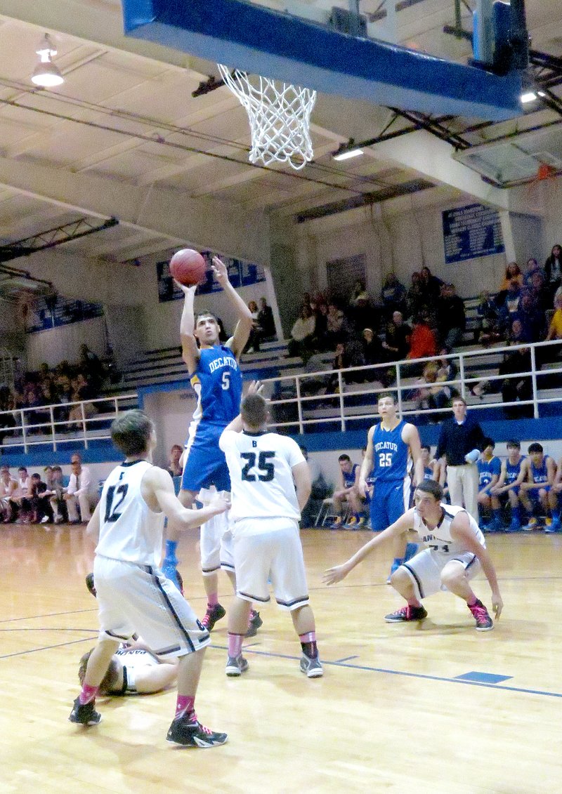 Photo by Mike Eckels Mario Urquidi, Decatur senior, shoots for two over Bigelow defenders during regional playoffs at JC Westside in Coal Hill on Feb. 26. In spite of the enormous effort put forth by the Bulldogs in the second half, the Panthers took the victory, 61 to 56, to advance to the semifinals of the 2A West regional tournament.