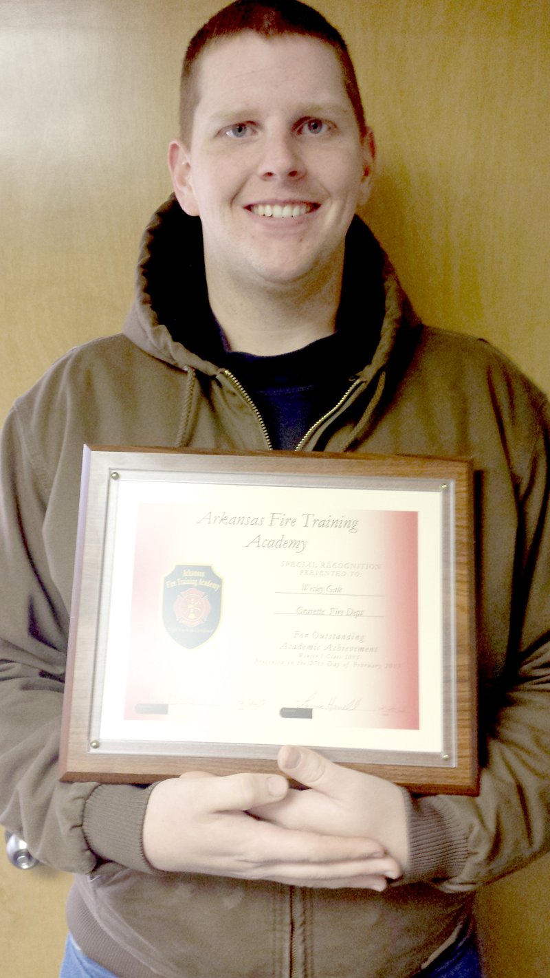 Fire Awards Wesley Gale (left), a volunteer firefighter EMT with the Gravette Fire Department, displays the certificate he received from the Arkansas Fire Training Academy. Gale graduated Feb. 26 from the eight-week basic firefighter course which was held at the academy in Camden. He was also awarded the Academic Achievement Award. Submitted Photo