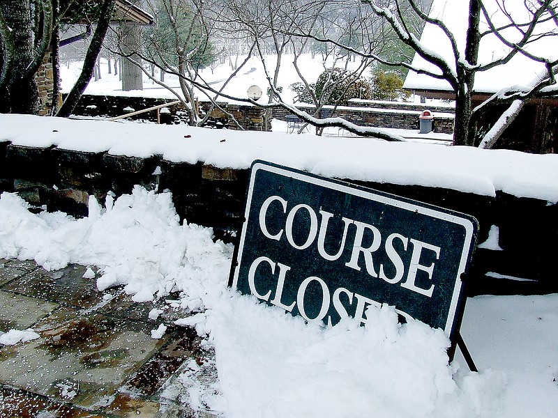 Tom Throne/The Weekly Vista Snow piles up around the &#8220;Course Closed&#8221; sign at the Bella Vista Country Club Golf Course.