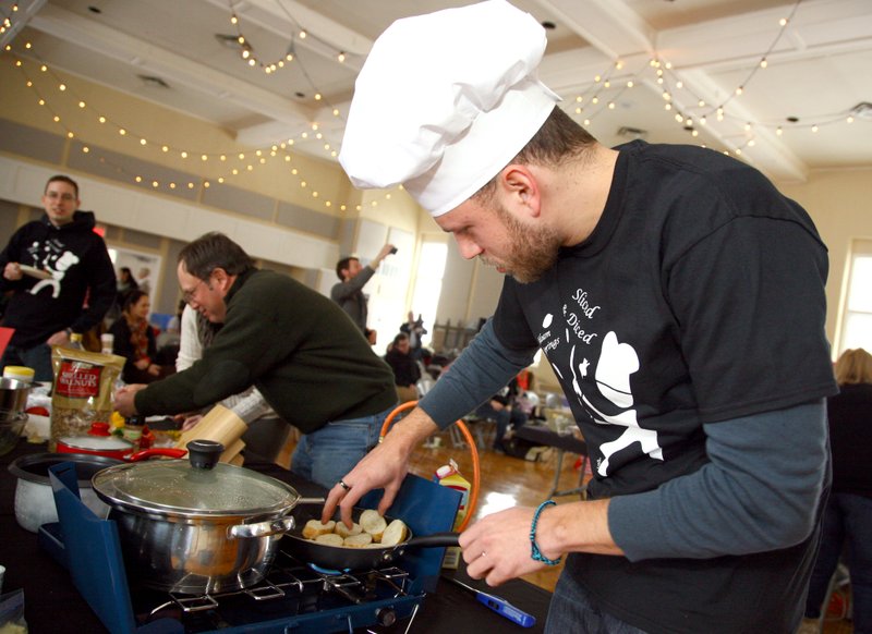 Melissa Gute/Herald-Leader Chef Jacob Little toasts french bread for his appetizer during the Slice and Diced cooking competition at the Community Building Saturday. Little was one of three chefs to compete in the event, which was hosted by The Garden in Siloam Springs and Bridges to Wellness. It served as a kickoff event for The Garden, a nonprofit organization that is planning to build a community garden behind Grace Episcopal Church at 617 N. Mount Olive St.