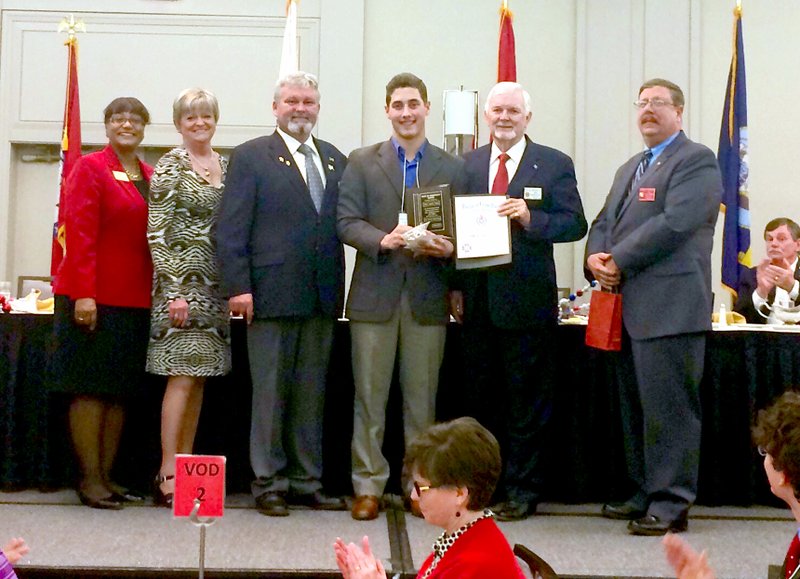 Photo submitted John Austin Earles, center, is pictured winning the Arkansas VFW Voice of Democracy audio-essay competition in Little Rock on Feb. 7. He was awarded a $5,000 college scholarship and an all-expenses-paid trip to the national competition in Washington D.C. Earles is a senior at Siloam Springs High School.