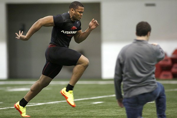 Arkansas defensive end Trey Flowers runs during the program's pro day on Wednesday, March 4, 2015, at Walker Indoor Pavilion in Fayetteville. 