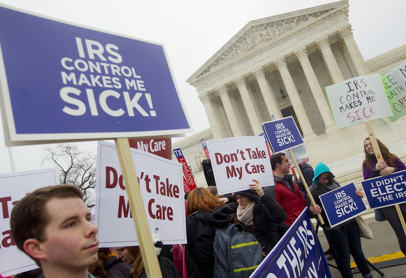 Demonstrators stand outside the Supreme Court in Washington on Wednesday, March 4, 2015, as the court hears arguments in King v. Burwell, a major test of President Barack Obama's health overhaul which, if successful, could halt health care premium subsidies in all the states where the federal government runs the insurance marketplaces. 