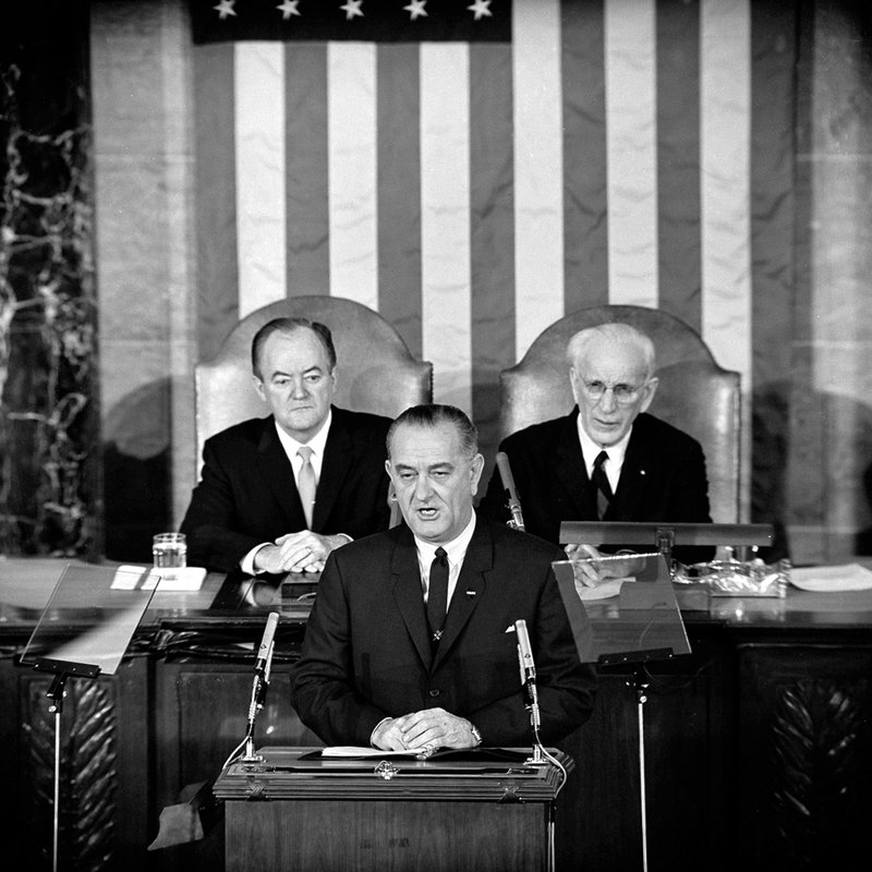 In this March 15, 1965 file photo, U.S. President Lyndon B. Johnson addresses a joint session of Congress in Washington where he urged the passing of the Voting Rights Act and spoke of his experience as a young teacher in a segregated, Mexican-American school. Vice President Hubert Humphrey is at left and House Speaker John McCormack is at right. 