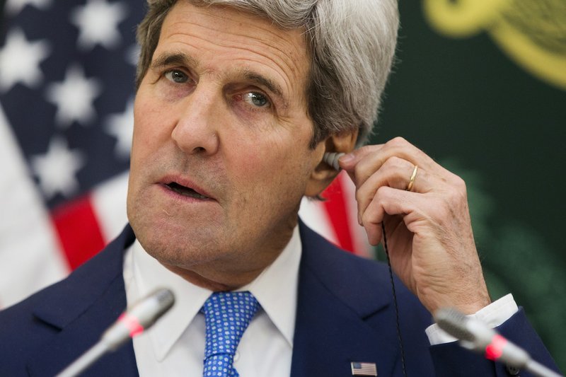 U.S. Secretary of State John Kerry puts in an ear piece for translation during a news conference with Saudi Foreign Minister Saud bin Faisal bin Abdulaziz Al Saud on Thursday, March 5, 2015, in Riyadh, Saudi Arabia. Kerry sought Thursday to ease Gulf Arab concerns about an emerging nuclear deal with Iran and explore ways to calm instability in Yemen and other troubled nations in the Middle East.