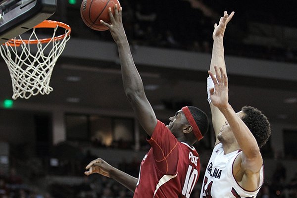 Arkansas' Bobby Portis (10) drives to the basket in front of South Carolina's Michael Carrera (24) iduringthe first half of an NCAA college basketball game, Thursday, March 5, 2015, in Columbia, S.C. (AP Photo/Travis Bell)