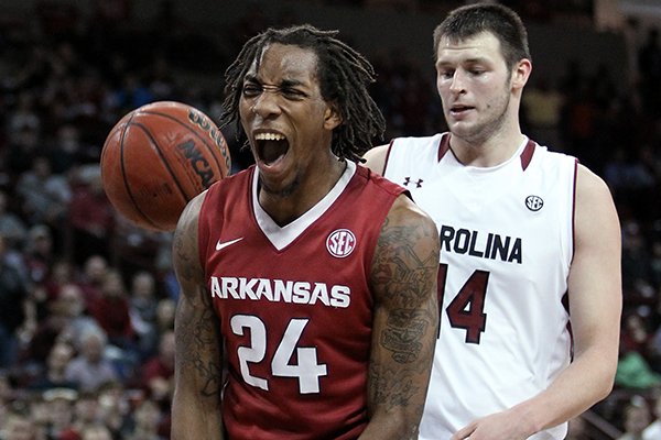 Arkansas' Michael Qualls (24) celebrates after scoring, in front of South Carolina's Michael Carrera, right, and Laimonas Chatkevicius during the second half of an NCAA college basketball game, Thursday, March 5, 2015, in Columbia, S.C. Arkansas won 78-74. (AP Photo/Travis Bell)