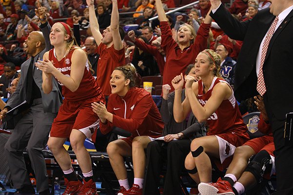 Arkansas' Melissa Wolff (from left), Katie Powell and Joey Bailey celebrate in the closing minutes of their victory over Ole Miss' during the SEC Women's tournament at Verizon Arena in North Little Rock on Thursday, March 5, 2015.