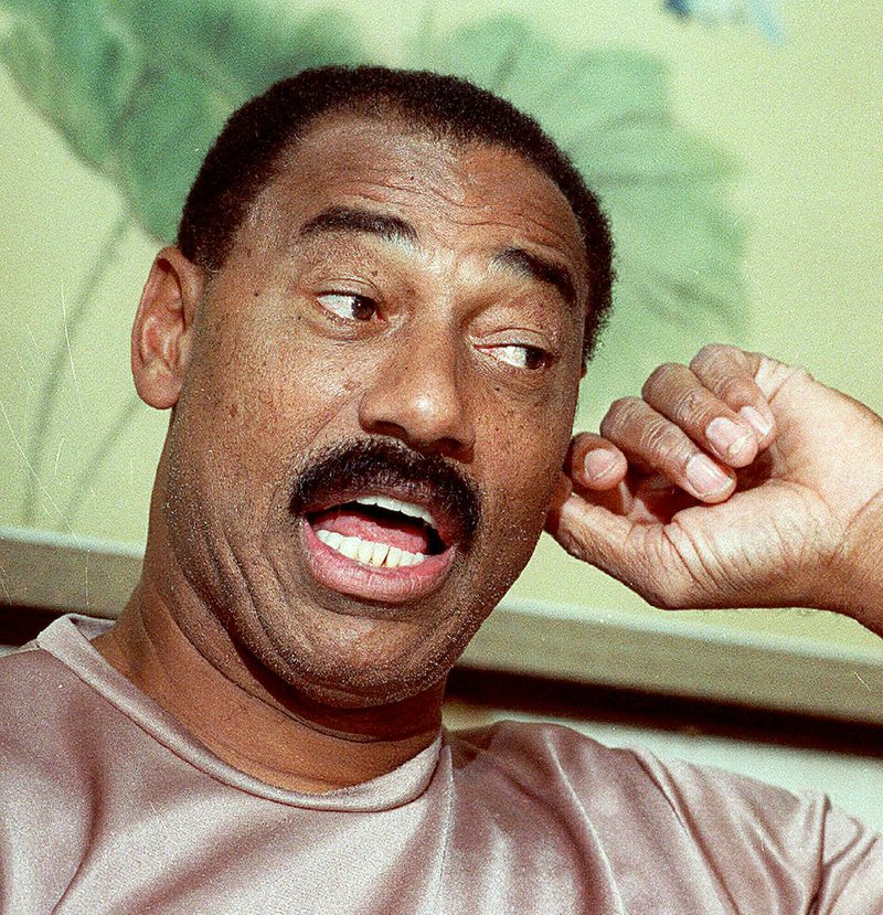 Basketball great Wilt Chamberlain tugs on his ear during a news conference in Cherry Hill, N.J., in this January 29, 1991 photo. 