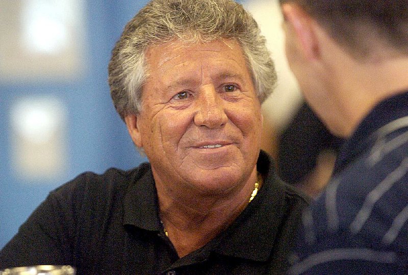 Former race car driver Mario Andretti greets race fan Tim Evelyn at the Firestone auto care center in Fayetteville, N.C., Wednesday, May 3, 2006. 