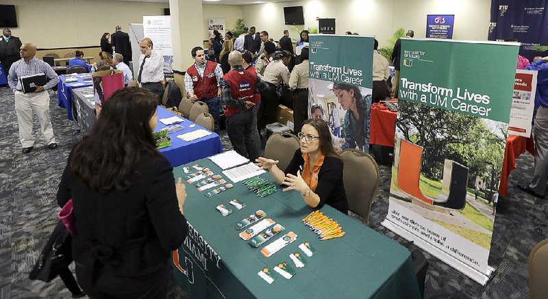 U.S. military veterans attend the annual Veterans Center and Resource Fair last month in Miami. Weekly applications for unemployment benefits rose 7,000 last week to a seasonally adjusted 320,000, the Labor Department said. 