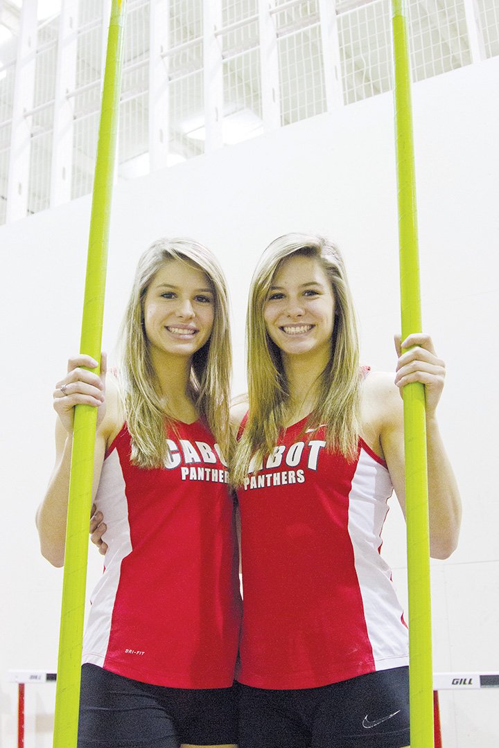 Tori, left, and Lexi Weeks push each other to reach their pole-vaulting goals. Lexi recently beat the national indoor pole-vaulting record.