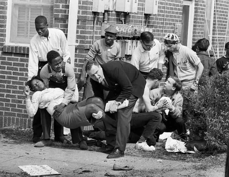 In this March 7, 1965 file photo, S.W. Boynton is carried and another injured man tended to after they were injured when state police broke up a demonstration march in Selma, Ala. Boynton, wife of a real estate and insurance man, has been a leader in civil rights efforts. The day, which became known as "Bloody Sunday," is widely credited for galvanizing the nation's leaders and ultimately yielded passage of the Voting Rights Act of 1965.