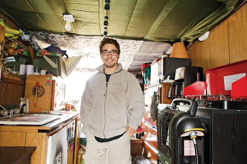 University of Central Arkansas student Branden Blume, 21, stands in his home, which is a refurbished bread truck. Blume said he lived in a UCA-owned apartment, but he decided to experience sustainable living, as well as save money, and he bought the truck on Craigslist. It had been lived in, so it had insulation. He rents a space in a Conway man’s yard for $100 a month and uses the homeowner’s electricity.