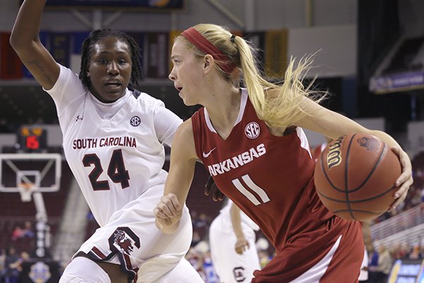 South Carolina's Aleighsa Welch (24) defends against Arkansas' Calli Berna (11) in the first half of a Southeastern Conference women's tournament NCAA college basketball game in North Little Rock, Ark., Friday, March 6, 2015. (AP Photo/Danny Johnston)