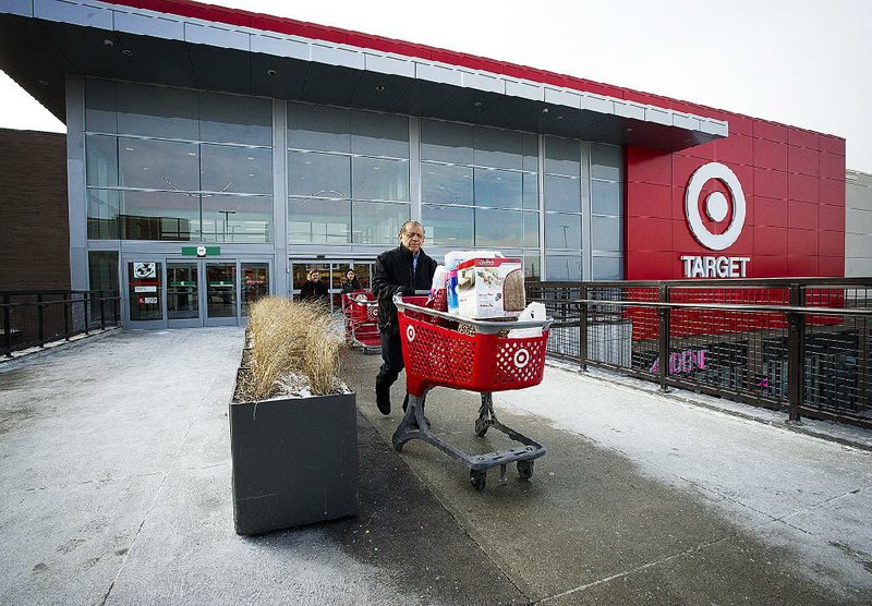 Shoppers exit a Target Corp. store with their shopping carts n Toronto, Ontario, Canada, on Thursday, Jan. 15, 2015. Target Corp. will walk away from Canada less than two years after opening stores there, putting an end to a mismanaged expansion that racked up billions in losses. Photographer: Kevin Van Paassen/Bloomberg
