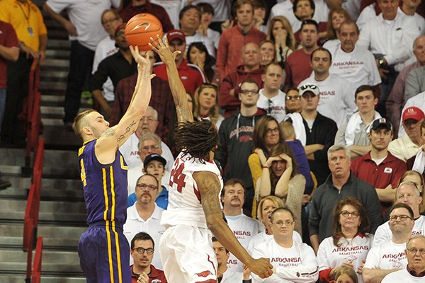 LSU guard Keith Hornsby shoots a 3-pointer over Arkansas' Michael Qualls as time expires during a game Saturday, March 7, 2015, at Bud Walton Arena in Fayetteville. 