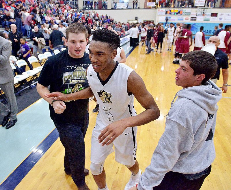 NWA Democrat-Gazette/BEN GOFF -- 03/07/15 Mitch Williams (left) and Zack Estrada, Bentonville seniors, congratulate Malik Monk as he leaves the court after Bentonville's victory over Springdale during the 7A State Tournament game in Wildcat Arena at Springdale Har-Ber on Saturday Mar. 7, 2015. 