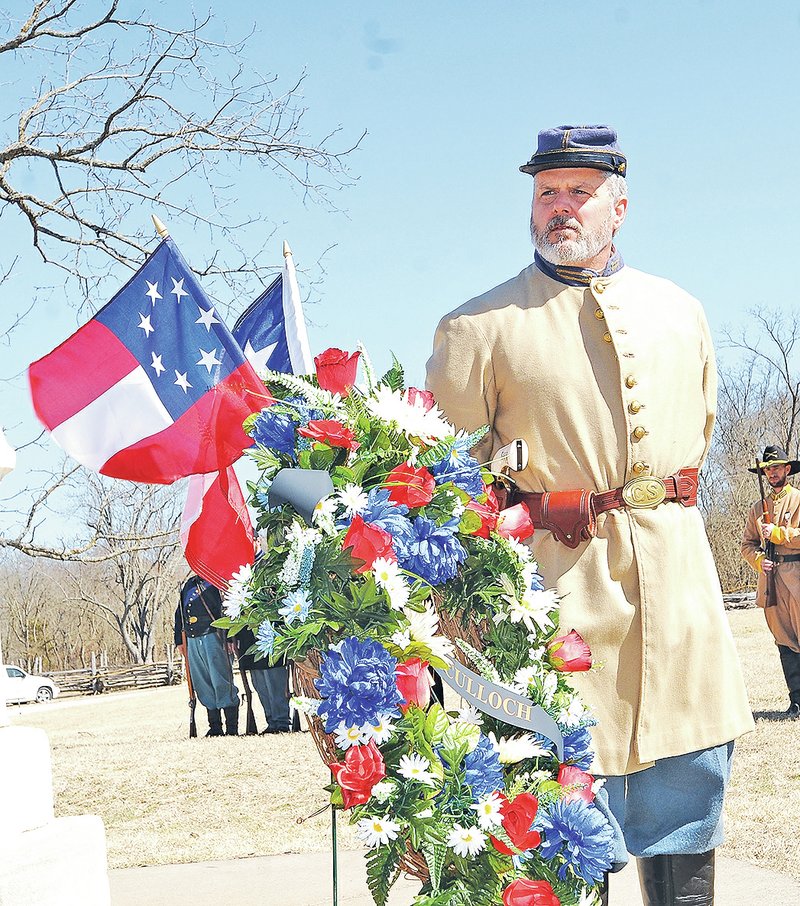 NWA Democrat-Gazette/FLIP PUTTHOFF Kim Nazario of Siloam Springs presents a wreath Saturday during a memorial for Gen. Benjamin McCulloch who fought at the Battle of Pea Ridge.