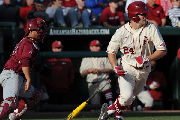 Chad Spanberger of Arkansas watches as a ball sails out of the infield against Loyola Marymount to score Rick Nomura during the third inning Saturday, March 7, 2015, at Baum Stadium in Fayetteville.