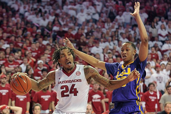 Arkansas forward Michael Qualls drives against LSU defender Tim Quarterman during a game Saturday, March 7, 2015, at Bud Walton Arena in Fayetteville. 