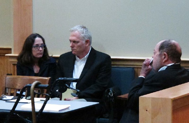 Film director Randall Miller, center, sits in a Georgia courtroom with his wife, Jody Savin before pleading guilty to charges of involuntary manslaughter and criminal trespassing Monday, March 9, 2015. Miller was filming "Midnight Rider," a biographical movie about singer Gregg Allman, when a freight train plowed into his crew on a railroad bridge last year. Camera assistant Sarah Jones was killed and six others were injured. (AP Photo/Russ Bynum)