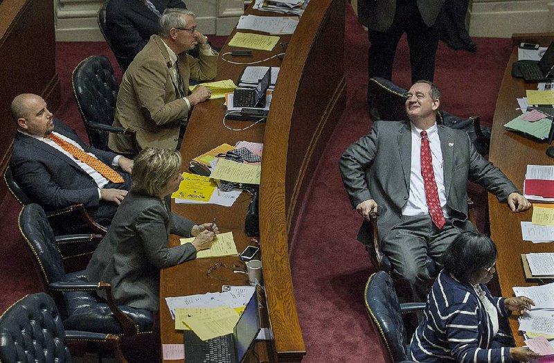 Arkansas Democrat-Gazette/BENJAMIN KRAIN --3/9/15--
Jimmy Hickey Jr, R-Texarkana, right, smirks in the direction of Jeremy Hutchinson, R-Little Rock, left, after a vote on his bill to modify the eligiblity requirements for tha Academic Challenge Scholarship program passed in the Senate Monday afternoon. Hutchinson and Linda Chesterfield, D-Little Rock, at bottom right, both voted against the bill.