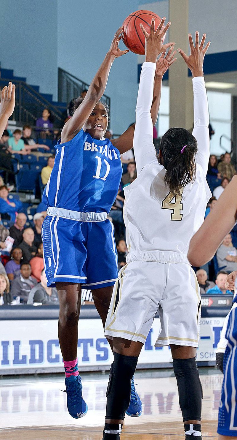 NWA Democrat-Gazette/BEN GOFF -- 03/08/15 Lauren Carroll of Bryant passes the ball as Kamry Orr of Little Rock Central defends during the 7A State Tournament game in Wildcat Arena at Springdale Har-Ber on Sunday Mar. 8, 2015. 