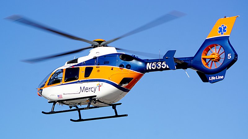 Photo by Randy Moll A Mercy helicopter lifted off from the parking lot of Gentry High School&#8217;s baseball and softball fields on Friday morning after loading a medical patient.