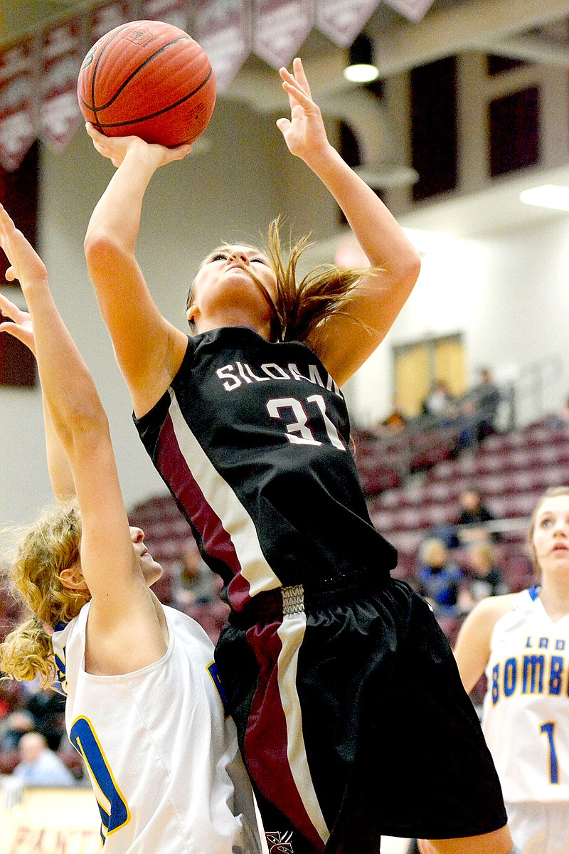 Bud Sullins/Special to the Herald-Leader Siloam Springs senior Mayse Pippin powers past a Mountain Home defender for a basket during Monday&#8217;s 6A state tournament quarterfinals. The Lady Panthers defeated the Lady Bombers 46-26.