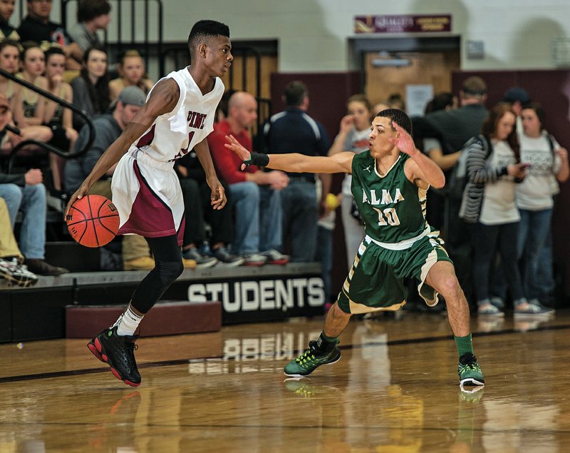 Pine Bluff’s Brandon Little (left) looks to drive toward the basket against Alma’s Braylon Parker during Tuesday’s semifinal game at the Class 6A boys state tournament in Siloam Springs. 