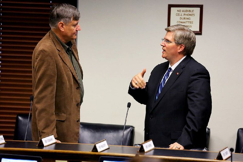 State Rep. Justin Harris, R-West Fork, (right) speaks Thursday with former Rep. Randy Alexander, R-Springdale, after a meeting of the House Education Committee in Little Rock. Harris’ attorney denied that Harris or his wife ever spanked two girls the couple had adopted. 