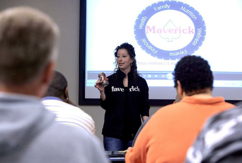 Leanne Kamps, a human resources generalist at Maverick USA, leads a wellness class for the company’s new truck drivers. Sitting behind the wheel and eating at fast-food restaurants leads to health problems for many truck drivers. 