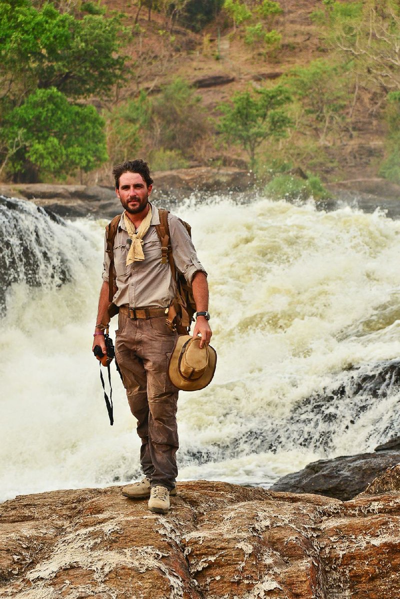 Levison Wood stands at the top of Murchsion Falls. The River Nile squeezes through a gap of six metres and drops forty metres to create one of the most epic sights on the whole course of the river and is called Murchsion Falls, named after the president of the Royal Geographical Society at the time when Samuel Baker first caught sight of the falls.