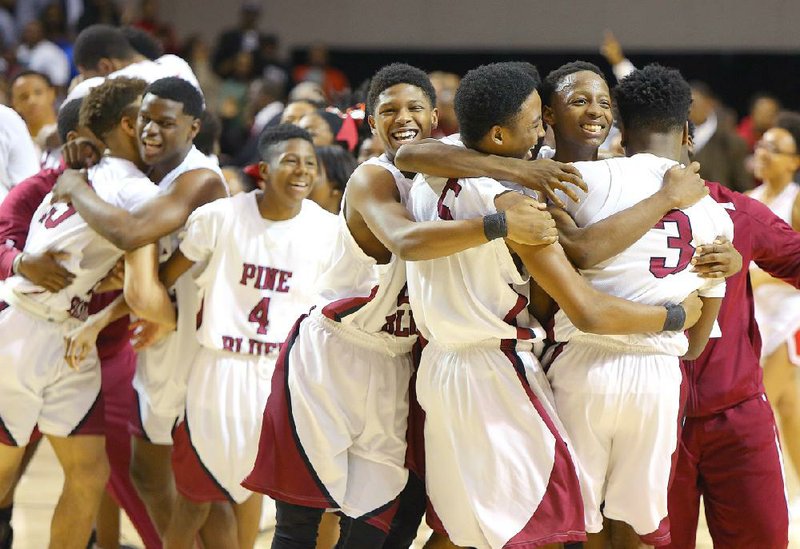 Pine Bluff players celebrate after beating Jonesboro 46-43 on Friday at Bank of the Ozarks Arena to win their first basketball state championship since 2003. 