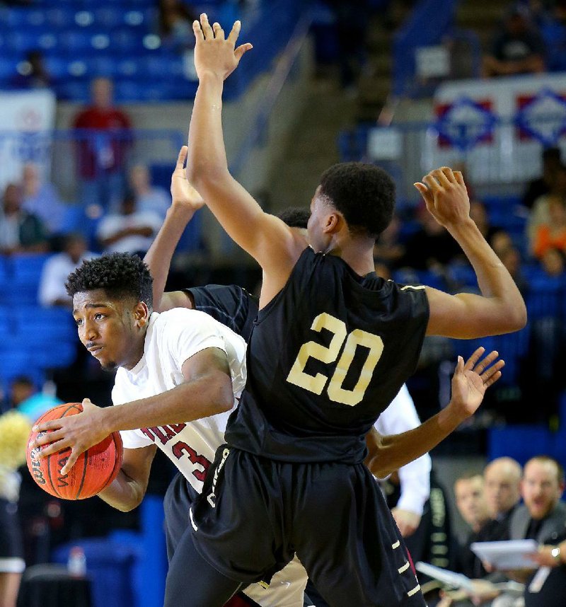 Pine Bluff’s Marcus Thomas tries to work his way through the Jonesboro defense during the Class 6A state championship game at Bank of the Ozarks Arena in Hot Springs on Friday. Thomas scored 14 points to lead the Zebras to their first state title since 2003.