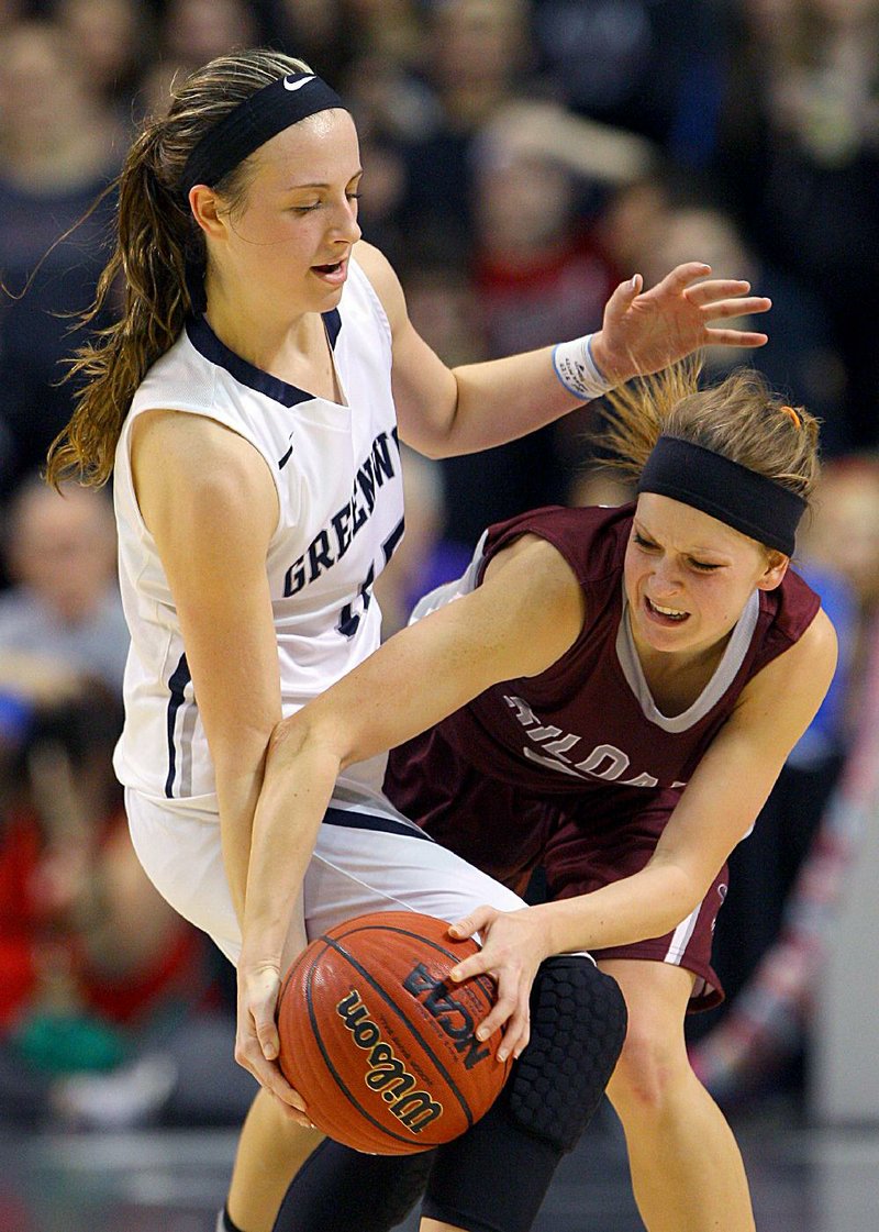 Greenwood’s Madison Goodner (left) strips the ball from Siloam Springs’ Taylor Gay during the Class 6A state championship game Friday at Bank of the Ozarks Arena in Hot Springs. Goodner’s nine steals tied a record in a state championship game. As a team, Greenwood had 22 steals.