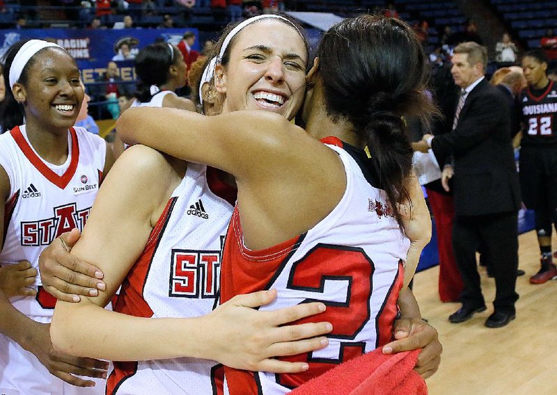 Arkansas State guard Hanna Qedan (center) hugs teammate Aundrea Gamble (24) following the Red Wolves’ 63-61 victory over Louisiana-Lafayette on Friday at the Sun Belt Tournament in New Orleans.