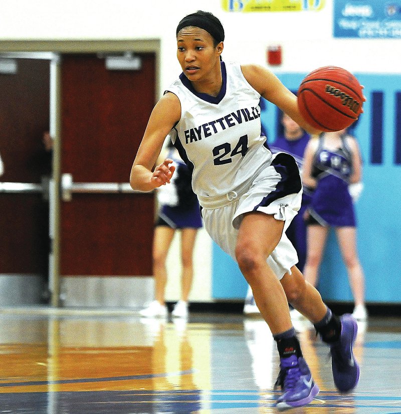 NWA Democrat-Gazette/J.T. WAMPLER DaShundra Morgan of Fayetteville drives Monday against Little Rock Central in the semifinals of the Class 7A state basketball tournament held at Springdale Har-Ber.