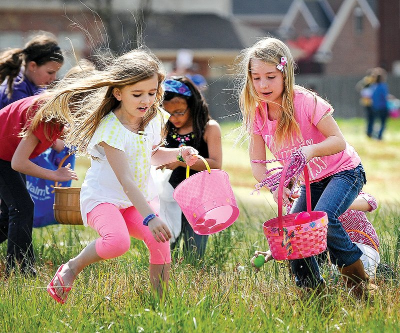 Jordan Rodabaugh (left) and Maci Roy,scramble to find eggs during last year’s annual Community Easter Egg Hunt at Rogers First Church of the Nazarene. Send details about this year’s Easter egg hunts to living@nwadg.com.