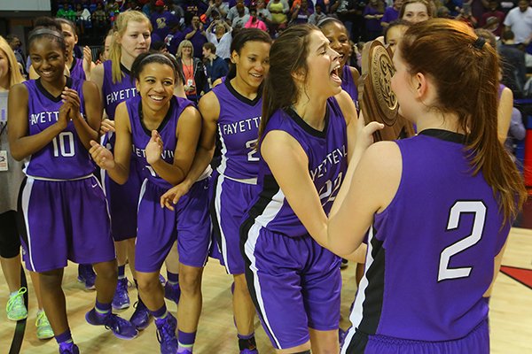 Fayetteville MVP Sydney Crockett (22) celebrates with teammates after defeating Conway during the Class 7A Girls State High School Basketball Championship in Hot Springs, Ark., on Saturday, March 14, 2015.