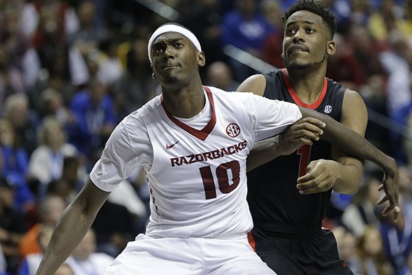 Arkansas forward Bobby Portis (10) and Georgia forward/center Yante Maten (1) wait for a rebound during the second half of an NCAA college basketball game in the semifinal round of the Southeastern Conference tournament, Saturday, March 14, 2015, in Nashville, Tenn. (AP Photo/Mark Humphrey)