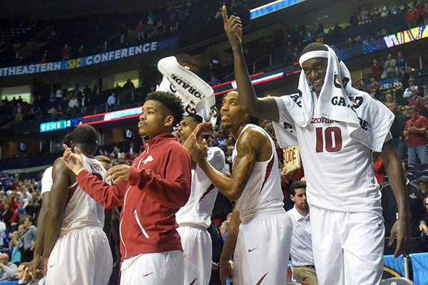 Arkansas players celebrate in the closing seconds of their win over Georgia on Saturday, March 14, 2015, in the SEC Tournament at Bridgestone Arena in Nashville, Tenn. 