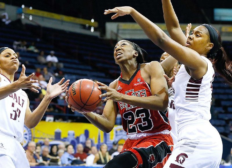 UALR guard Ka’Nesheia Cobbins (left) and forward Kaitlyn Pratt try to defend Arkansas State forward Jasmine Hunt (23) as she drives to the basket during the Trojans’ 78-72 victory over the Red Wolves on Saturday at the Sun Belt Tournament in New Orleans.