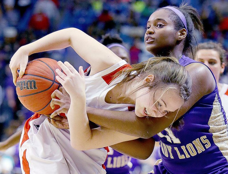 Marmaduke’s Abby Meredith (left) tries to keep the ball away from England’s Shavonta Blanks during the Class 2A state championship game in Hot Springs on Saturday. 

