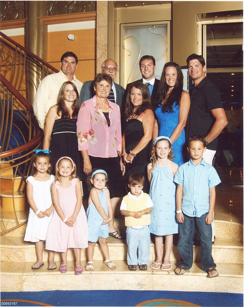 Submitted photo FEARLESS FAMILY: Hot Springs native Adam Brown, back right, gathered with his wife, Kelley, second from back right, and his family for one of their last family pictures before he died in 2010. Adam Brown's family and thousands from around the world continue to use his story and his memory for inspiration for new acts of kindness and humanitarian efforts.