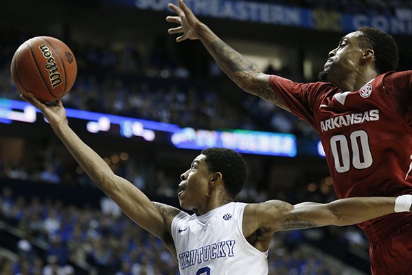 Kentucky guard Tyler Ulis (3) shoots against Arkansas guard Rashad Madden (00) during the second half of the NCAA college basketball Southeastern Conference tournament championship game, Sunday, March 15, 2015, in Nashville, Tenn. (AP Photo/Steve Helber)