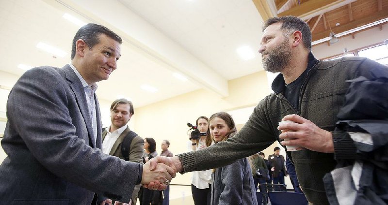 U.S. Sen. Ted Cruz, R-Texas, a tea party favorite and possible presidential candidate in 2016, left, shakes hands with Peter Smith during a visit to the Strafford County Republican Committee Chili and Chat on Sunday, March 15, 2015, in Barrington, N.H. (AP Photo/Jim Cole)